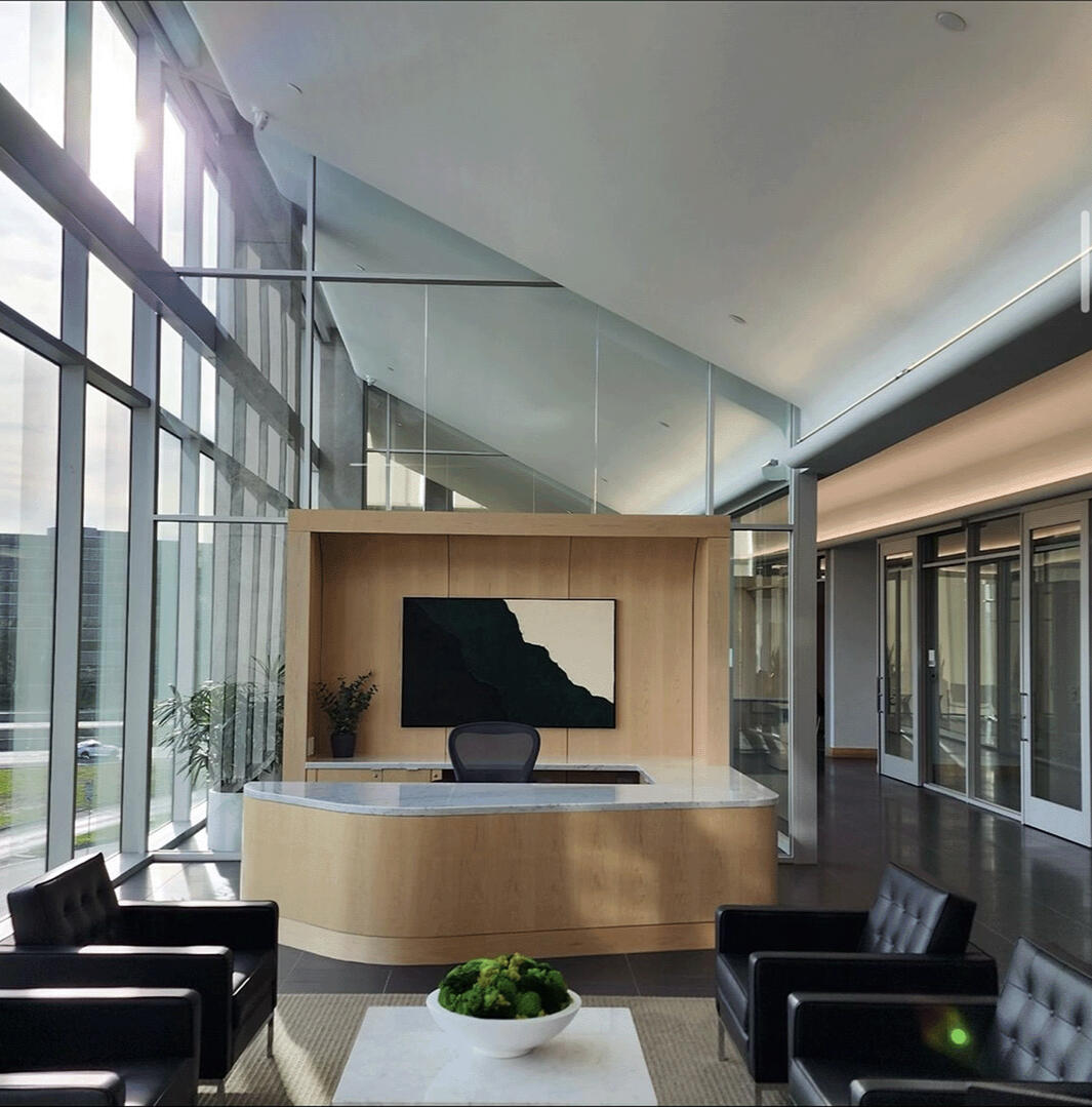 Commercial Office Interior Design | Workplace Buildout Commercial office interior featuring lounge seating, biophilic design elements, custom furnishings, brass accents, and hospitality-inspired workplace amenities within a modern office buildout.
