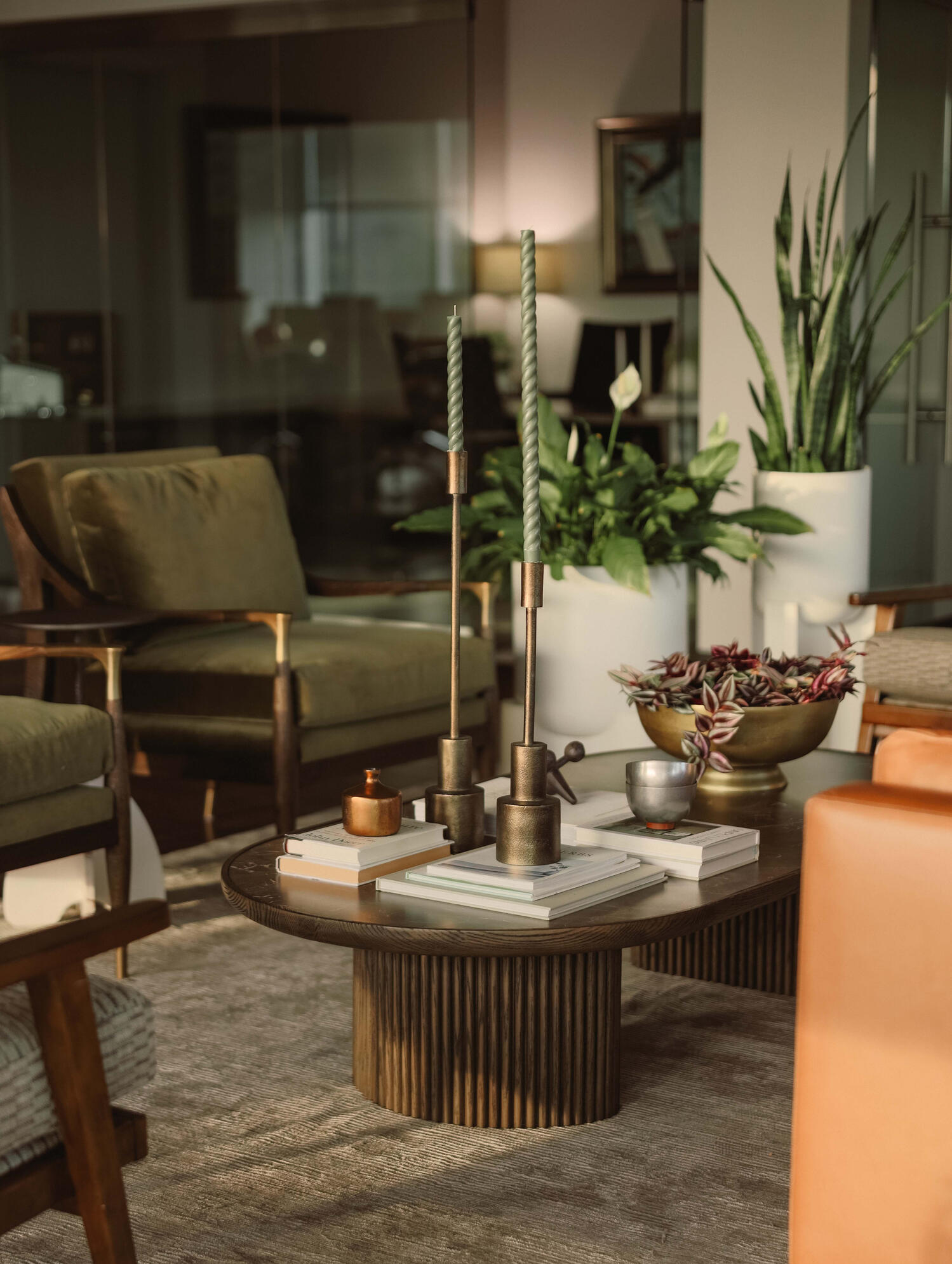 Commercial Office Interior Design | Workplace Buildout Commercial office interior featuring lounge seating, biophilic design elements, custom furnishings, brass accents, and hospitality-inspired workplace amenities within a modern office buildout.